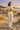 Female model in the Cornsilk New York tee with ivory trousers