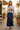 Female model in the white New York tee with a navy maxi skirt
