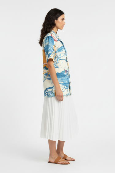 Female model in white midi skirt and tan sandals