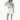 Female model in white shorts and tan sandals