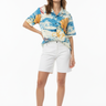 Female model in white shorts and tan sandals