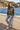 Female model in woodland camo hoodie and light-wash jeans