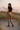Female model showcasing the back and side of the printed joggers