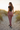 Female model showcasing the back and side of the rose joggers