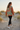 Female model showcasing the sweatshirt back with black leggings