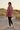 Female model showcasing the sweatshirt back with black leggings
