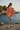 Female model showcasing the sweatshirt back with boardshorts