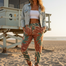 Female model styling the joggers with a denim jacket and bandeau