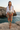 Female model styling the joggers with a white linen shirt