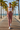 Female model styling the rose joggers with a white crop tank