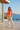 Female model styling the sunburst sweatshirt with cream joggers