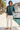 Female model wearing hoodie with ivory trousers at marina