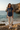 Female model wearing navy graphic tee and cream joggers