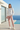 Female model wearing the floral sweatshirt with blush-pink joggers