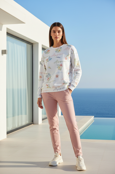 Female model wearing the floral sweatshirt with blush-pink joggers