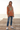 Female model wearing the hoodie with distressed blue jeans