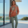 Female model wearing the hoodie with sage joggers