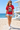 Female model wearing the red vampire skate tee in a daytime beach setting