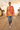 Female model wearing the sunburst sweatshirt with distressed jeans