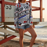 Female model wearing the sweatshirt with distressed denim shorts