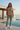 Female model wearing the sweatshirt with sage joggers