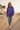 Female model wearing the tie-dye sweatshirt with distressed blue jeans