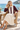 Female seaside café look with an ivory pleated skirt
