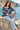 Female seated seaside look with light-wash jeans