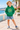 Five-year-old in green hoodie on a seaside promenade