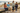 Four kids together on a coastal boardwalk