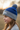 Girl age 9 wearing blue pom-pom beanie