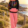 Golden-hour lighthouse look with coral-pink trousers