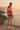 Golden-hour terrace editorial showing the hoodie back