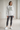 Heather Grey hoodie with charcoal leggings in an indoor studio