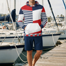 Hoodie editorial with navy boardshorts near sailboats