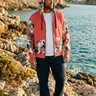 Hoodie styled with dark denim on a rocky coastline