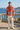 Hoodie styled with ivory linen trousers on a seaside terrace