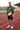 Hoodie styled with sports shorts at an athletics track