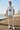 Ice blue ODDSON tee on a coastal boardwalk