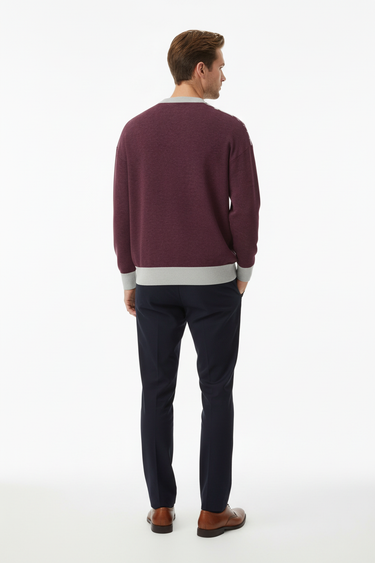 Back view of sweater with navy trousers in professional setting