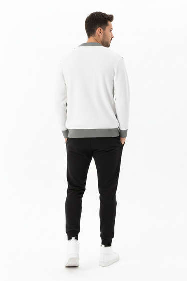 Back view of cardigan styled with black joggers