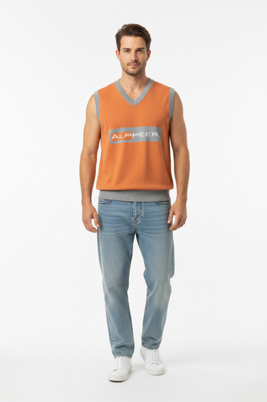 Alppeer orange vest styled casually with light wash denim and white sneakers