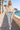 Ivory sweatshirt and camo leggings on a Mediterranean promenade