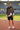 Jacket styled with sports shorts at an athletics track