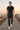 Joggers styled with a black tee on a beach boardwalk