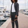 Joggers styled with a layered overshirt at a marina