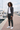 Joggers styled with a layered overshirt at a marina