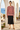 Knitted sweater styled with a black satin midi skirt