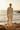 Look 1 – Wide-leg cream trousers, rocky shoreline