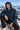 Look 9: snowy rock ledge overlook, half-zipped